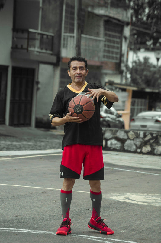 woman in red dress holding basketball