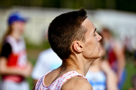 a man in a red and white tank top and a group of people
