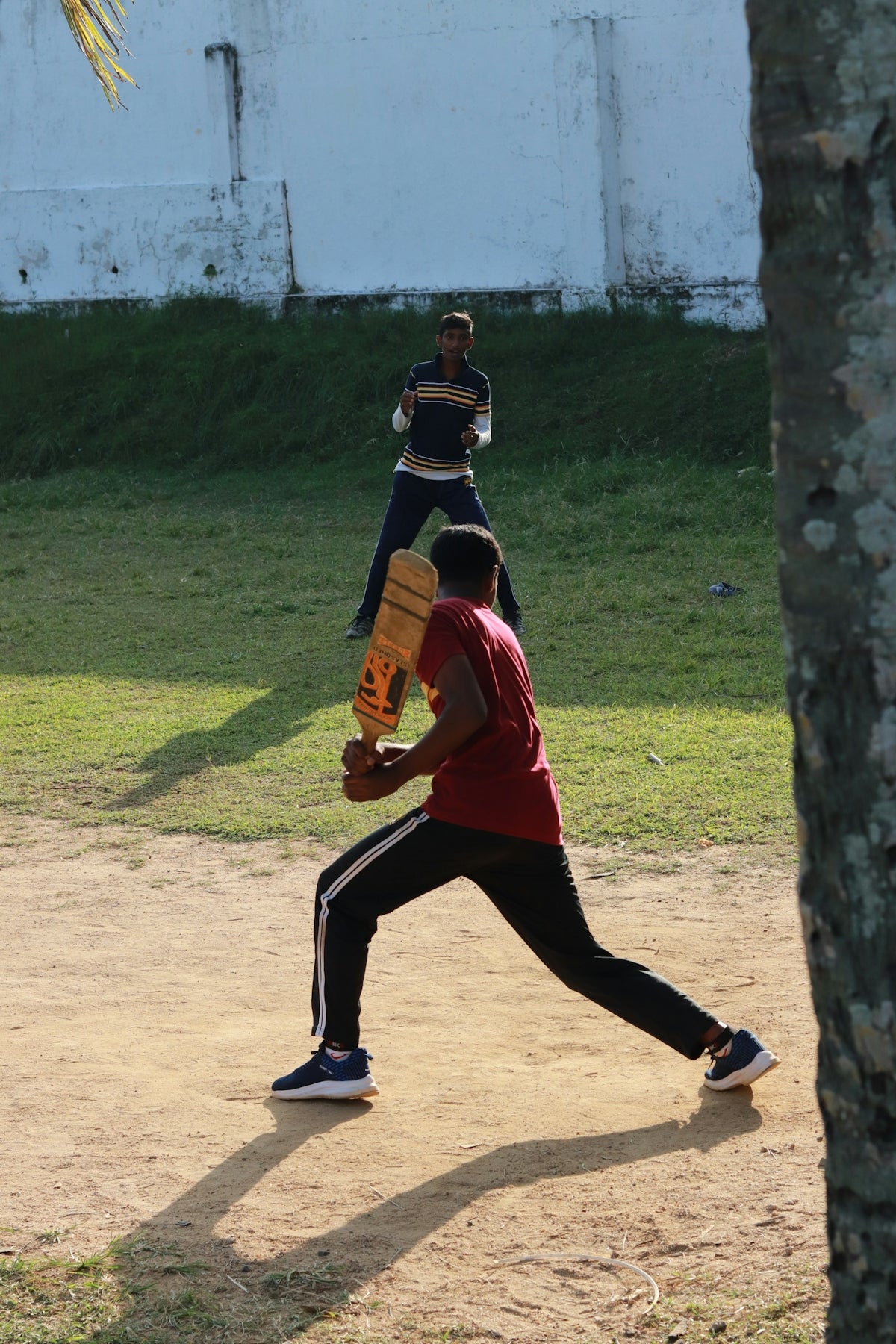 a man holding a catchers mitt on top of a field