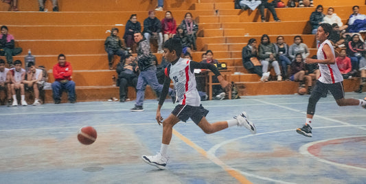 A group of young men playing a game of basketball