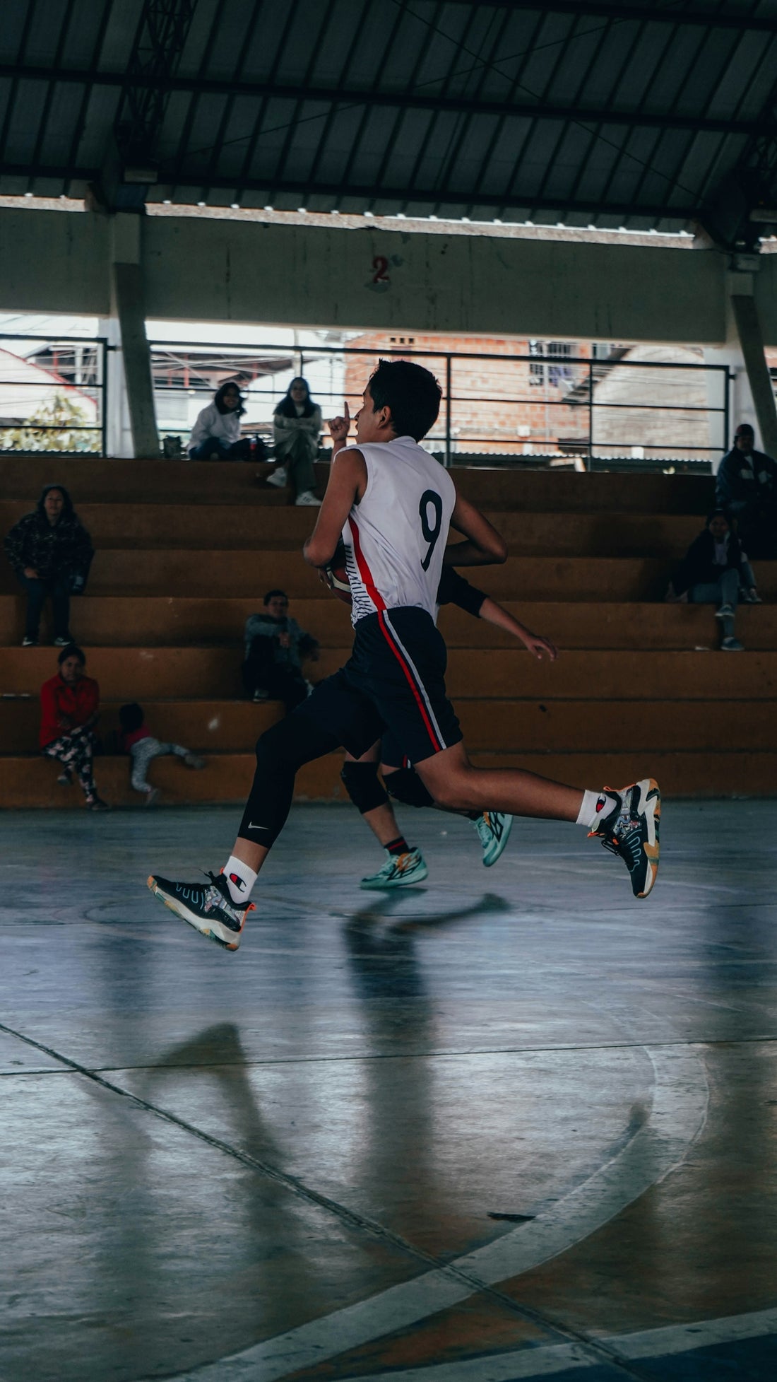 A group of young men playing a game of basketball
