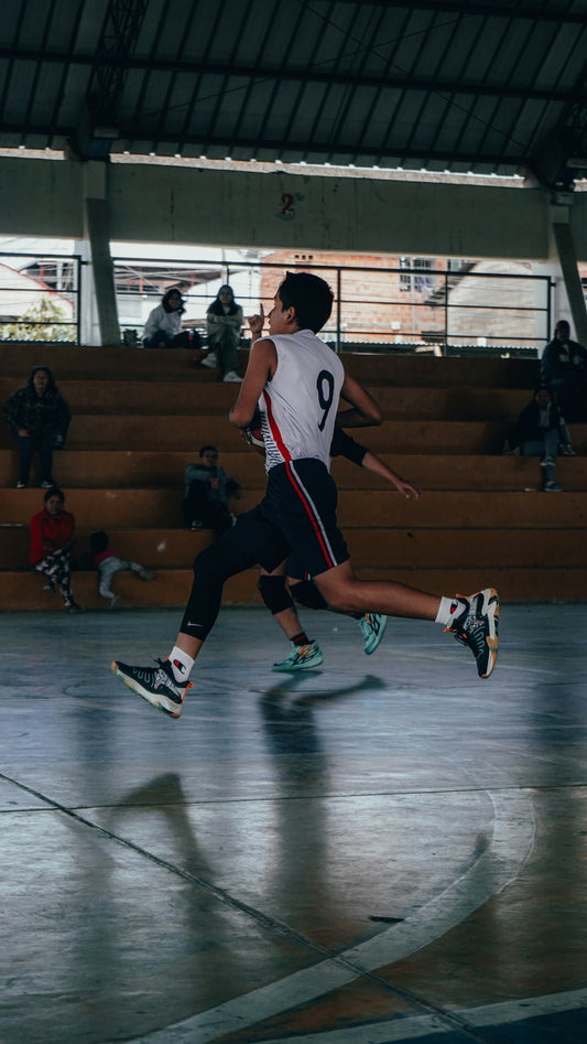 A group of young men playing a game of basketball