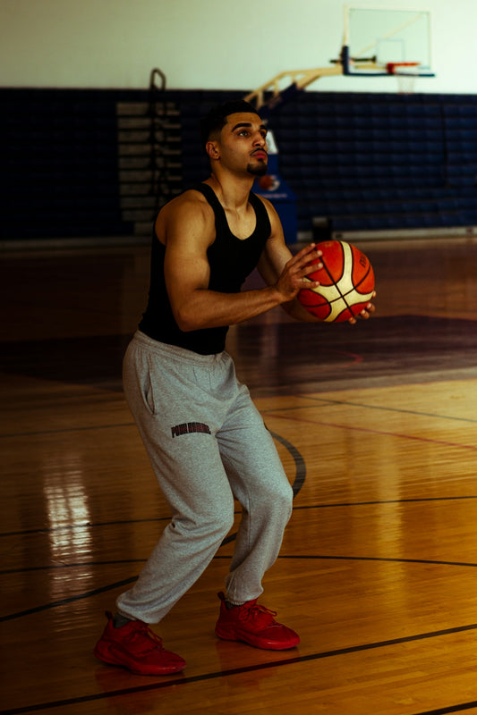 A man holding a basketball on a basketball court