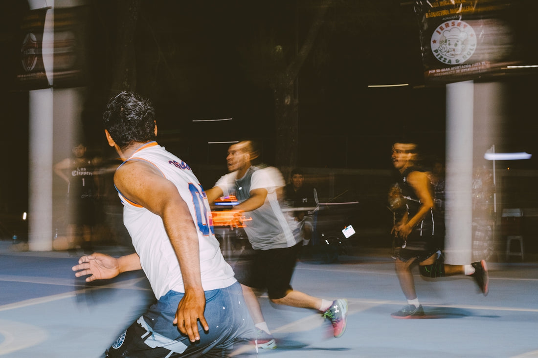 A group of young men playing a game of skateboard