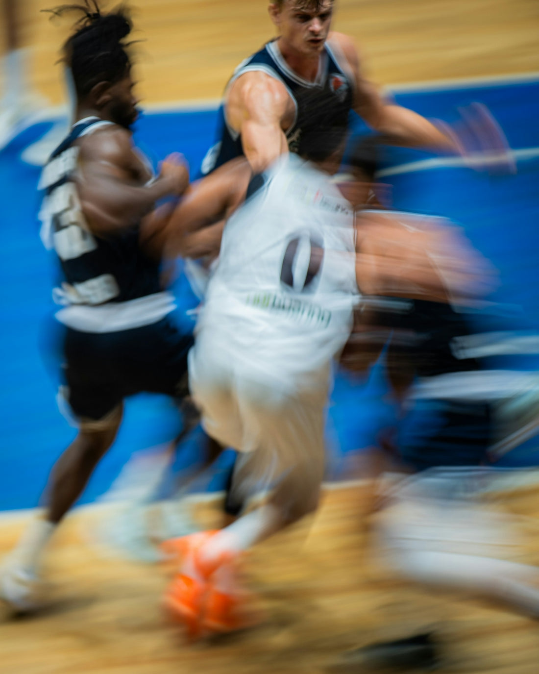 Basketball players in motion during a game.