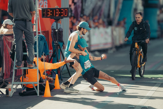 Runners collapse at finish line after race.