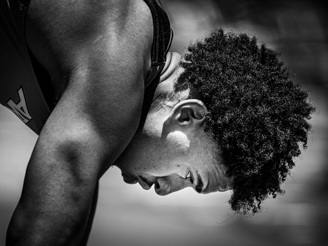 Close-up of a young athlete with curly hair.